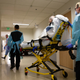 EMTs transferring a patient out of the acute care covid-19 unit at the Harborview Medical Center in Seattle, Washington on May 7, 2020